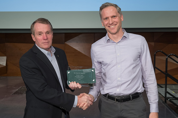 Eric Maloney accepts Outstanding Research Faculty Award