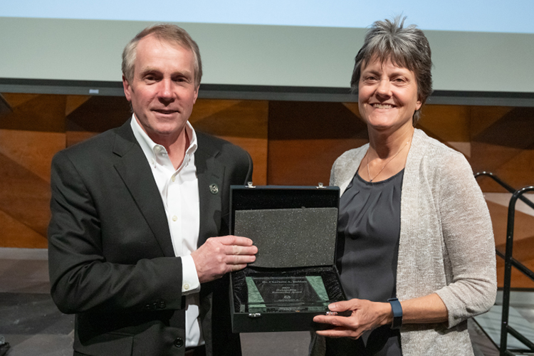 Charlotte DeMott accepts Outstanding Researcher Award