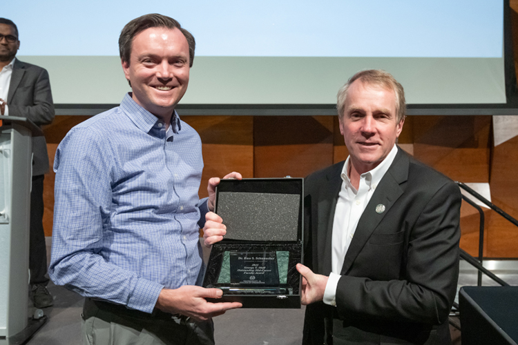 Russ Schumacher accepts George T. Abell Award for Outstanding Mid-Career Faculty