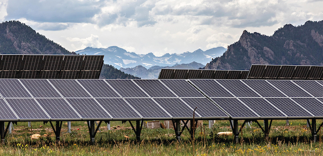Solar panels with mountains in the background