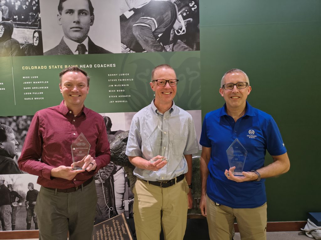 Three people with awards