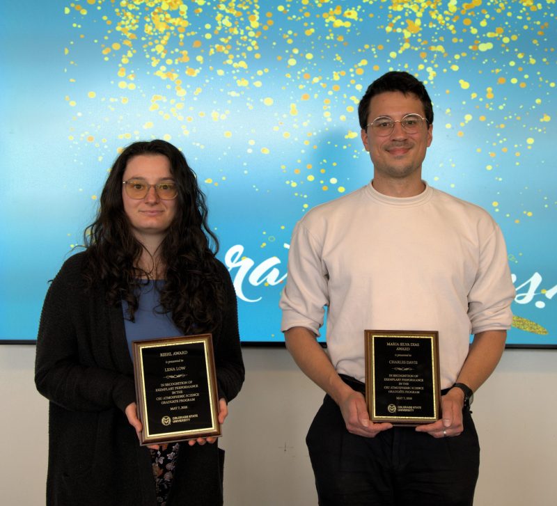 Two people with awards